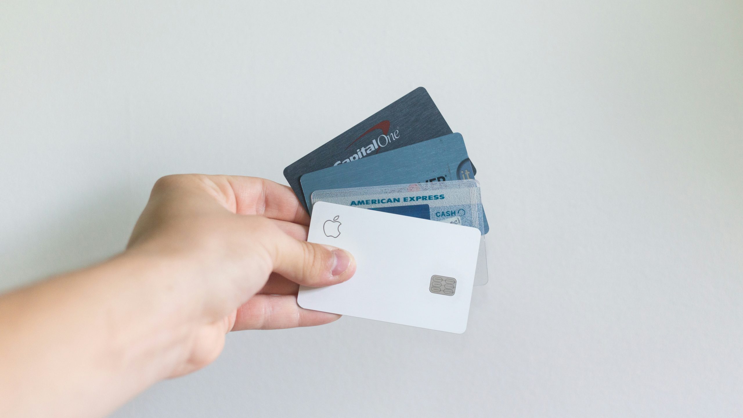 a person consolidating cards and cash