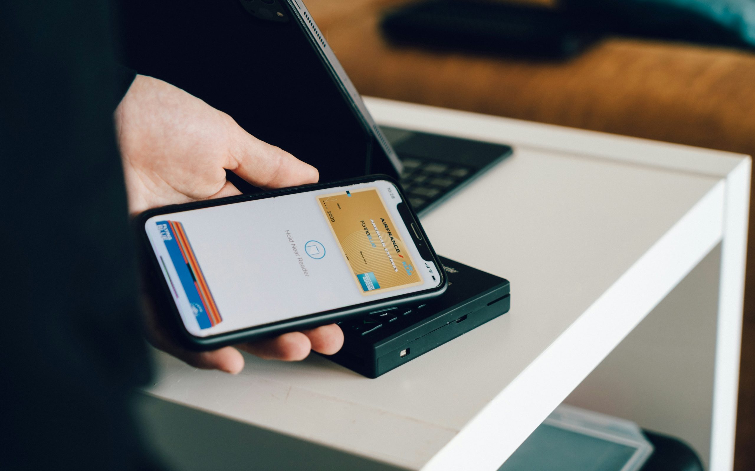 a prson using a phone to pay for a product
