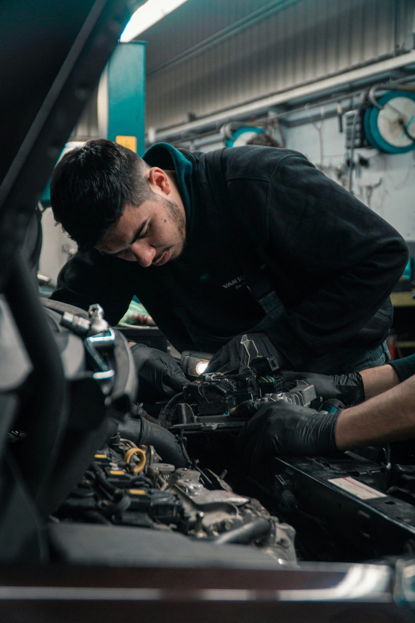 a man fixing his car