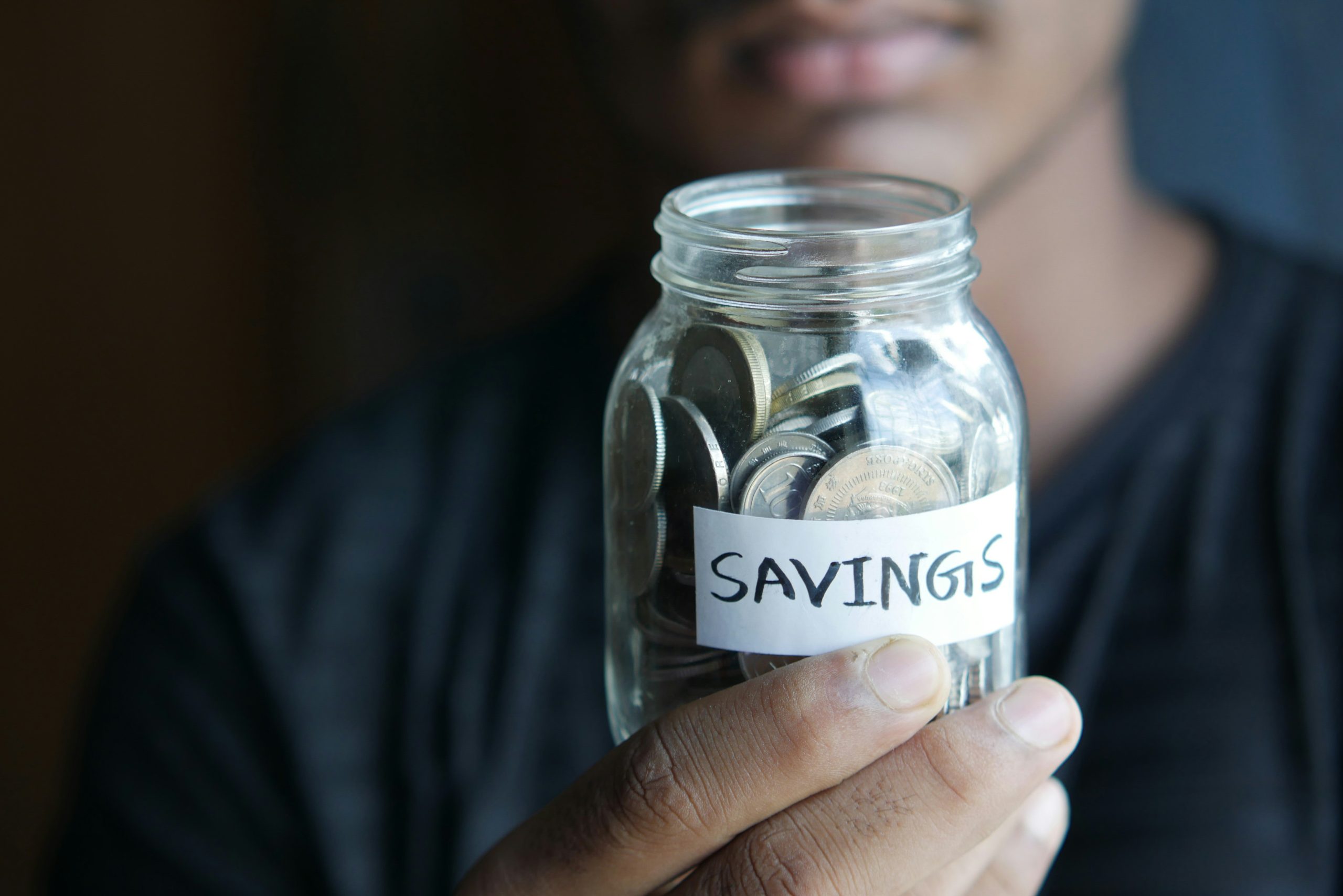 a man with a jar of savings