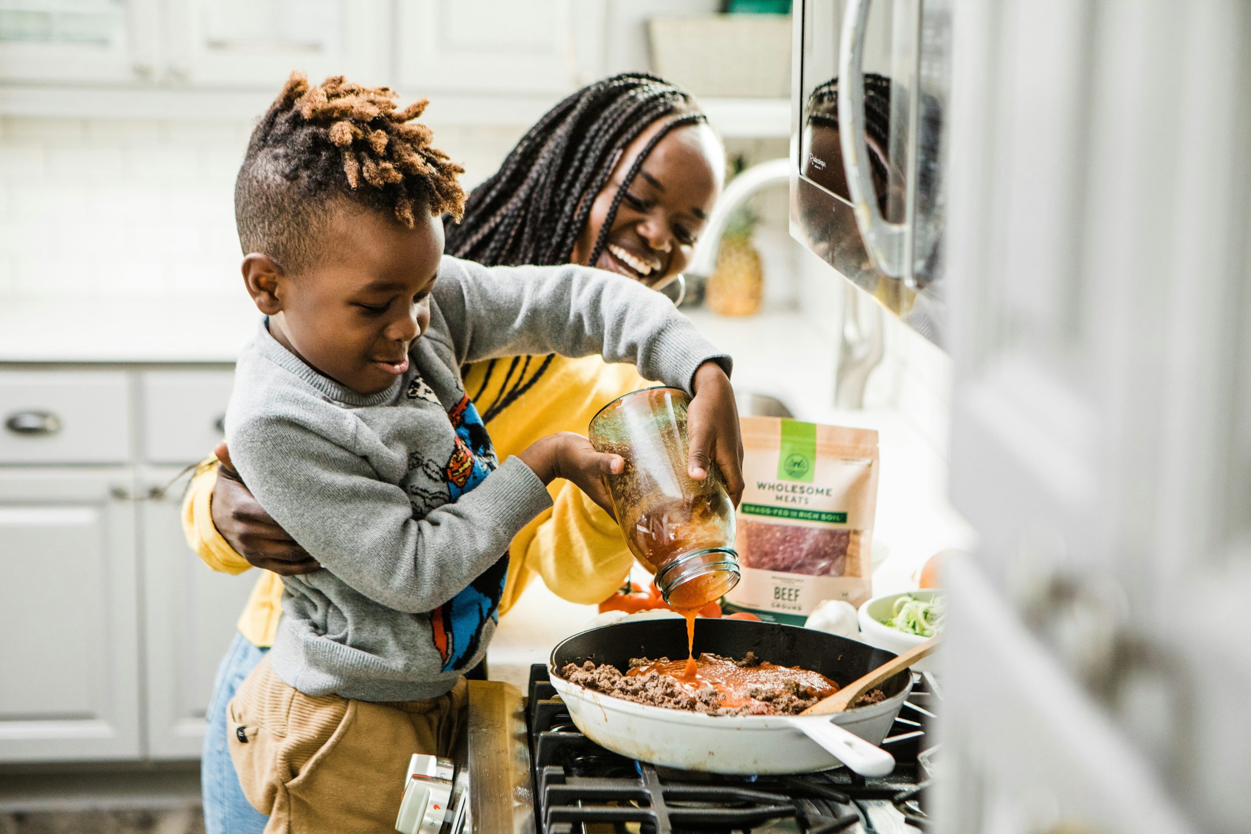 a mother and child cooking