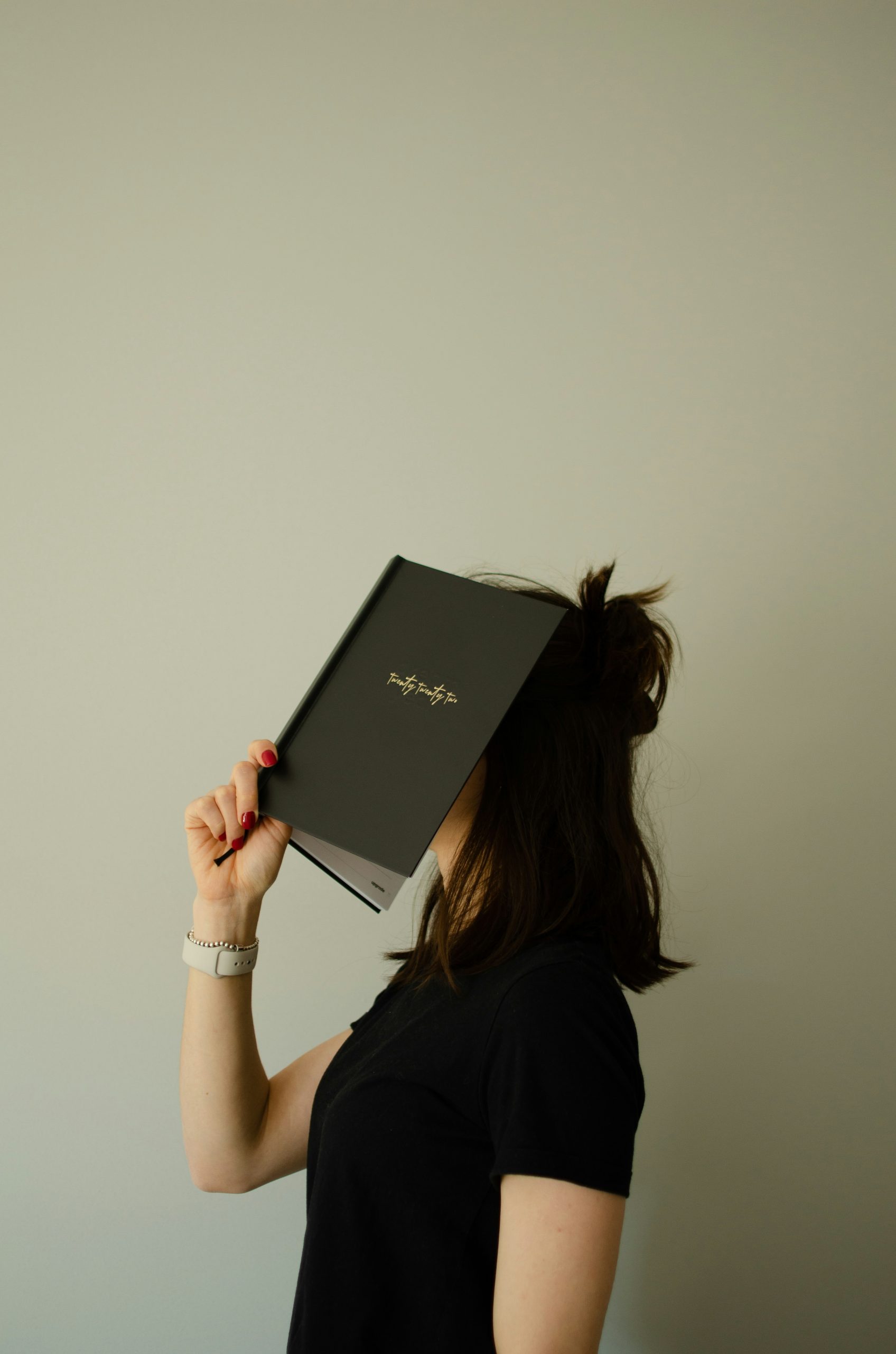 woman with her head in a notebook