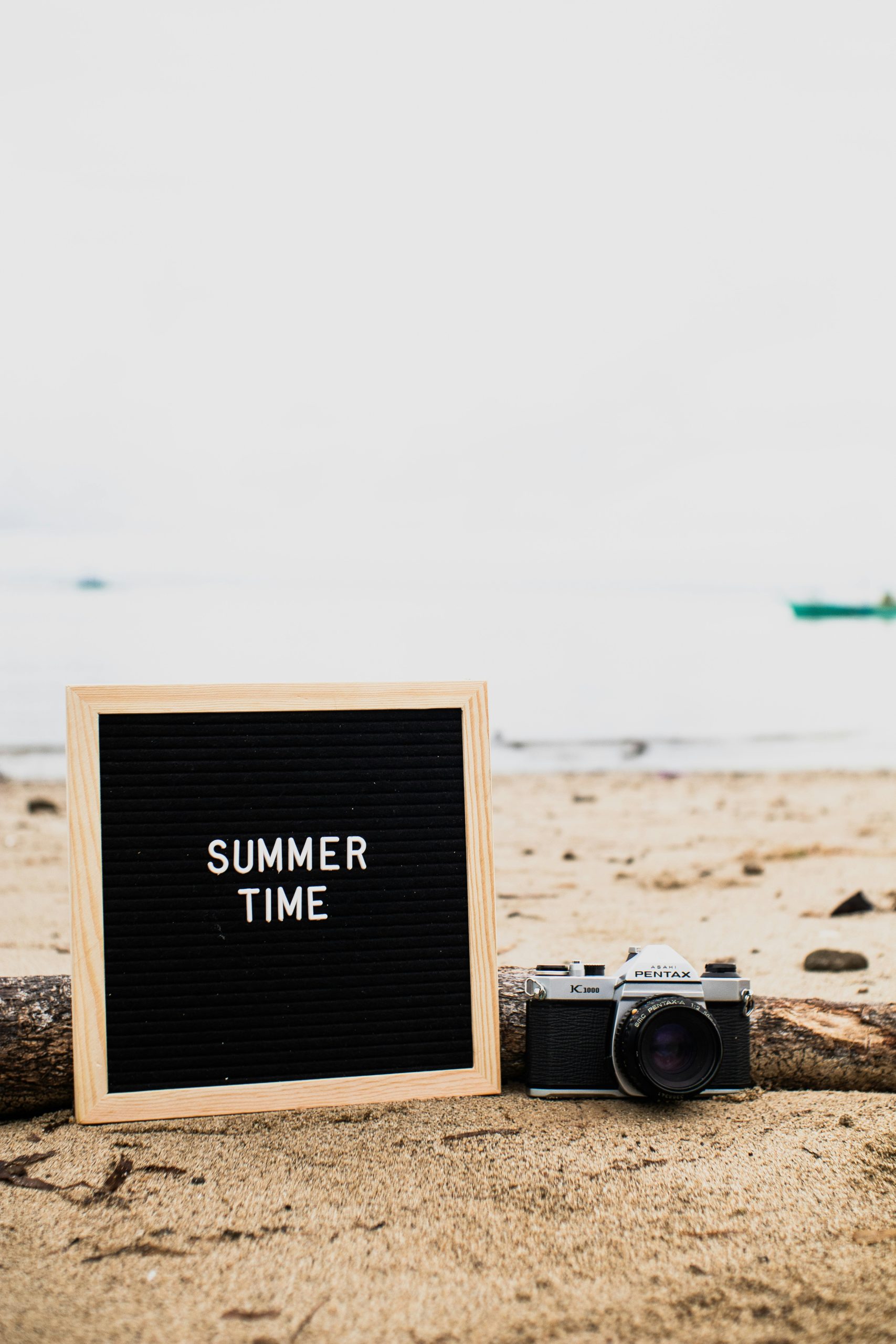 a summer time sign on beach