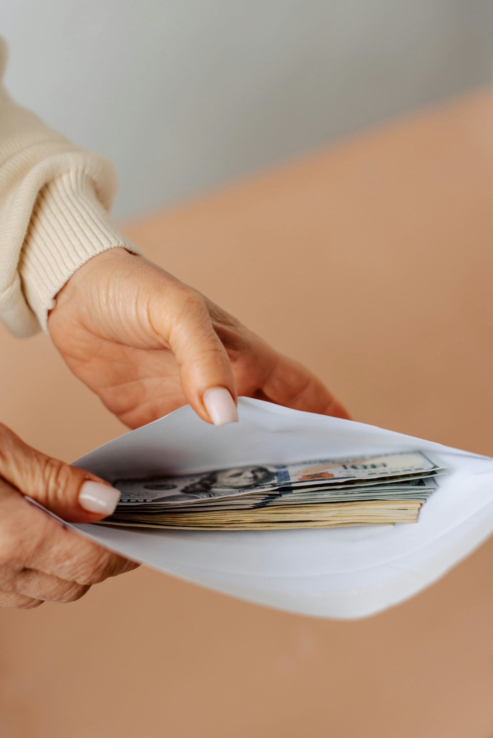 a woman with an envelope of dollars